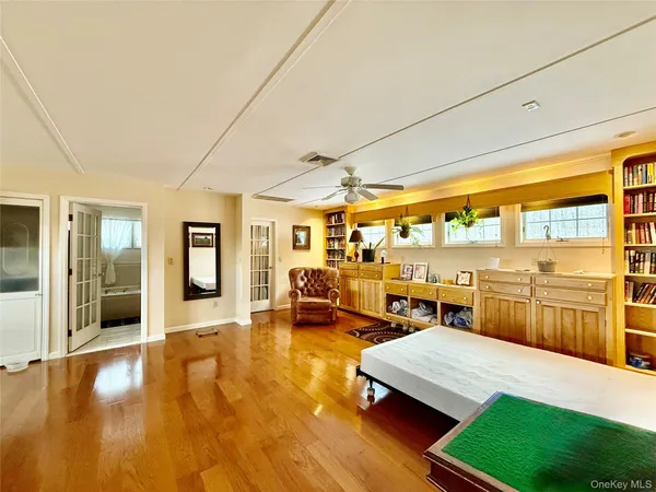 a room with lots of wooden furniture and large windows