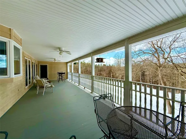 a view of two chairs in the balcony