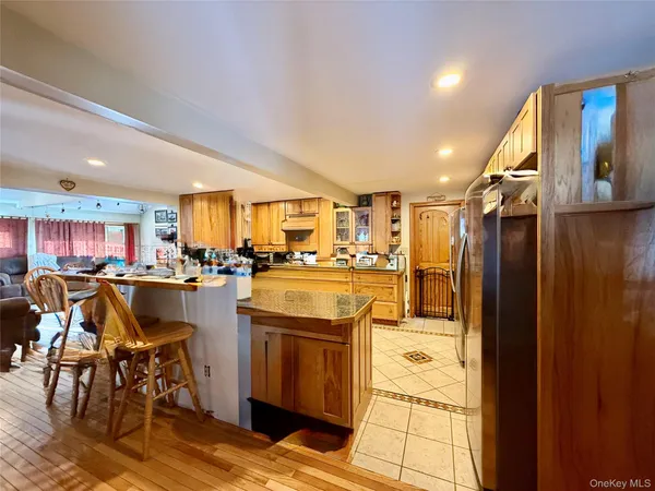 a kitchen with stainless steel appliances granite countertop a refrigerator and a stove top oven