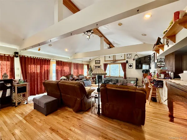 a living room with lots of furniture and kitchen view