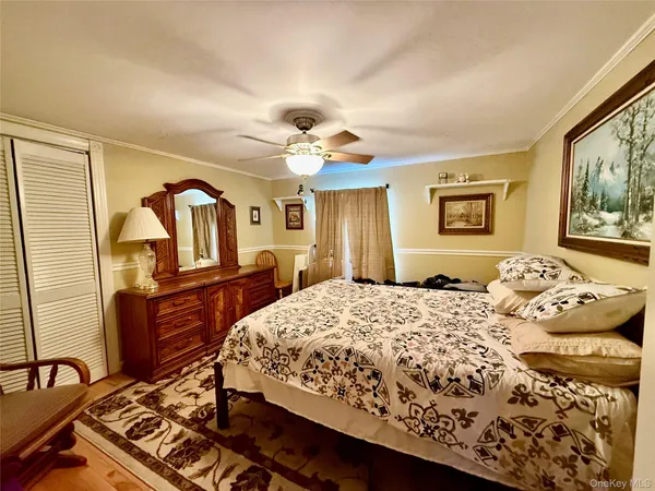 a bedroom with a large bed and a dresser