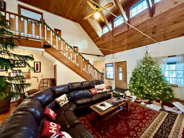 a view of a patio with couches table and chairs and potted plants
