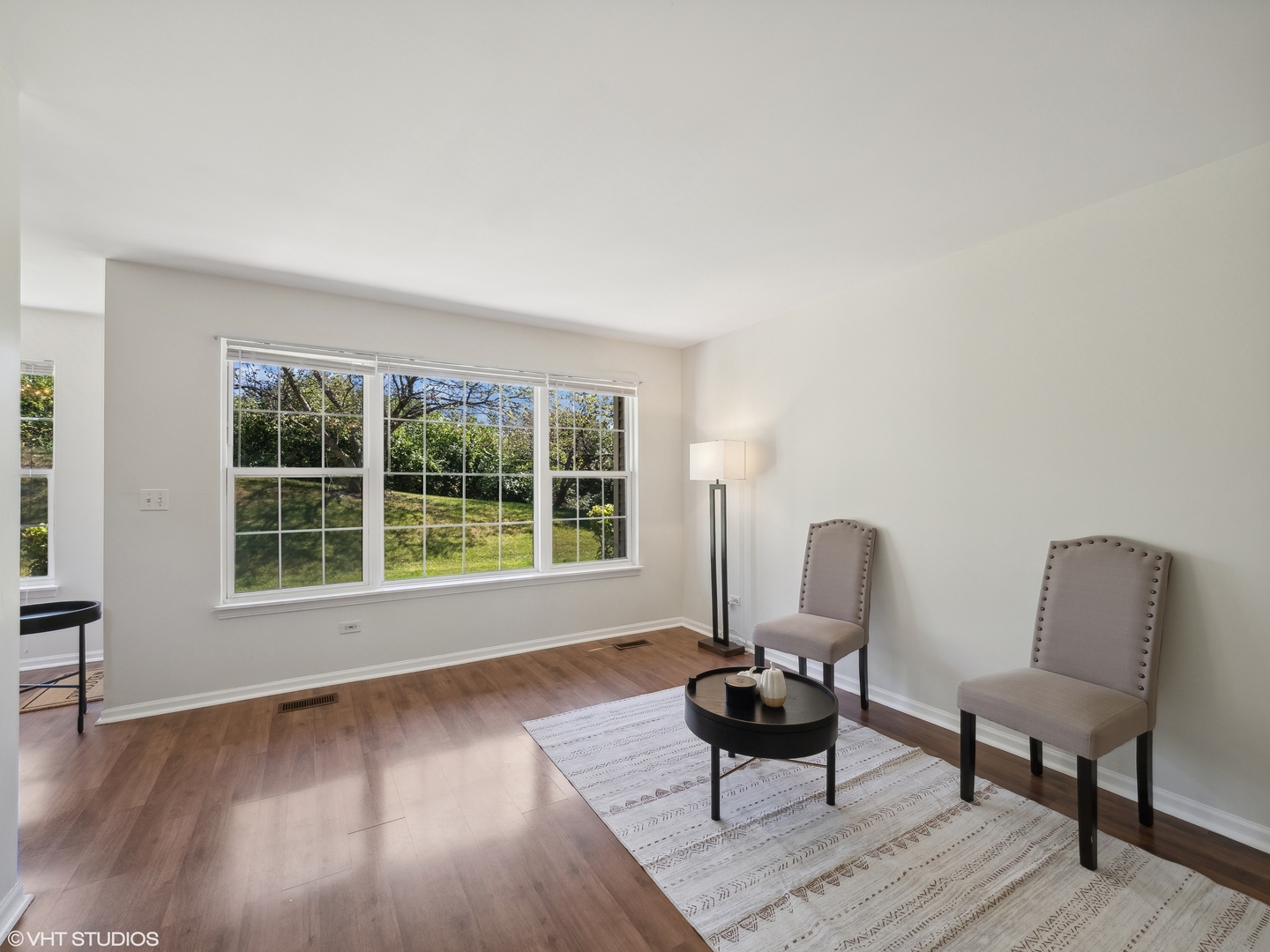 305 Buckingham Circle, Unit B Elgin, IL 60120 - Photo 11 of 20 a living room with furniture and a window