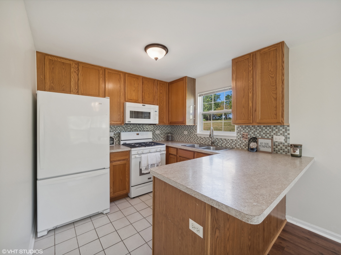305 Buckingham Circle, Unit B Elgin, IL 60120 - Photo 13 of 20 a kitchen with a appliances a sink and a refrigerator