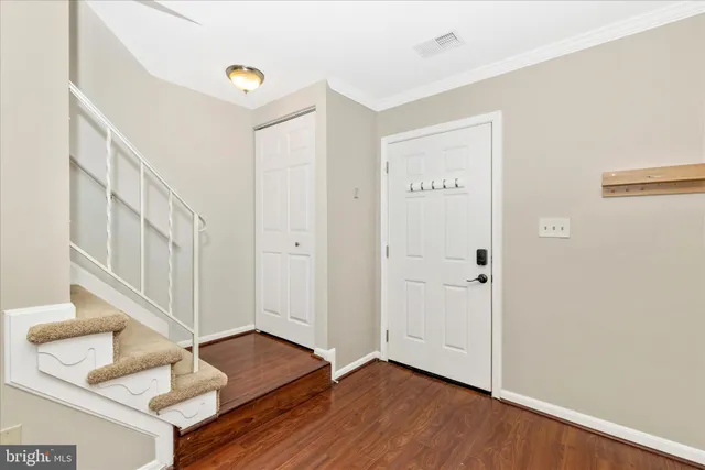 a view of an entryway with wooden floor