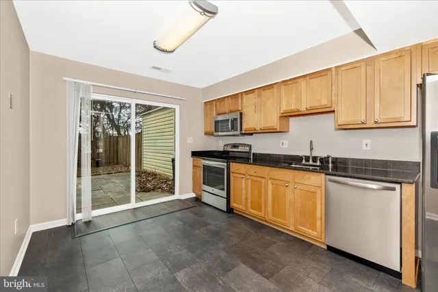 a kitchen with stainless steel appliances granite countertop a stove and a sink