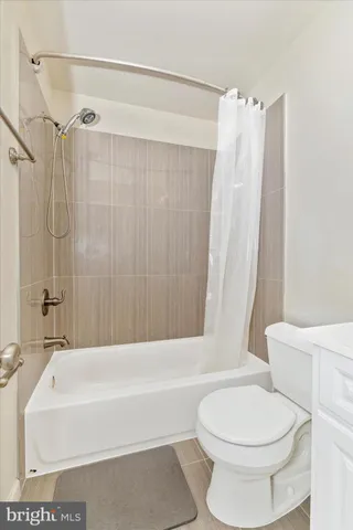 a bathroom with a toilet and a bathtub