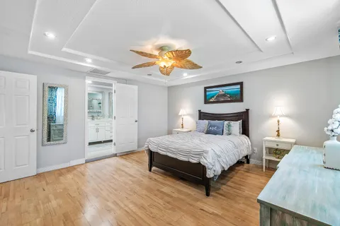 a spacious bedroom with a bed and a chandelier