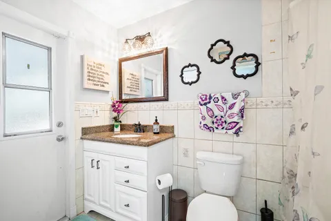 a bathroom with a toilet sink and mirror