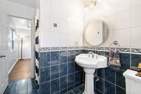 a bathroom with a sink a toilet and a mirror