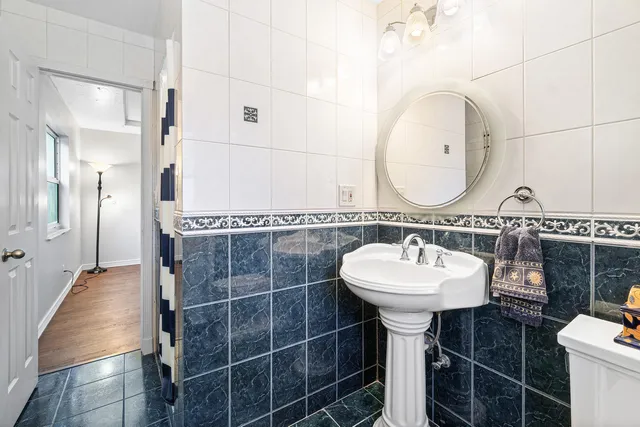 a bathroom with a sink a toilet and a mirror