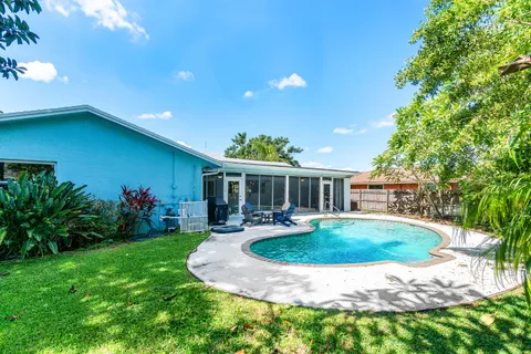 a view of a house with backyard sitting area and garden
