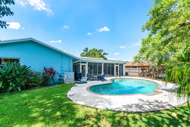a view of a house with backyard sitting area and garden