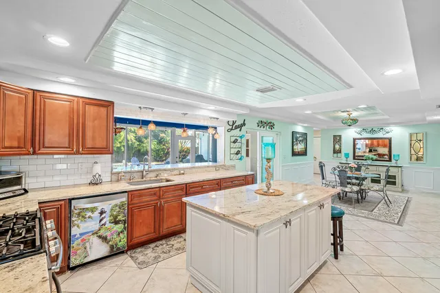 a kitchen with a stove a sink a dining table and chairs