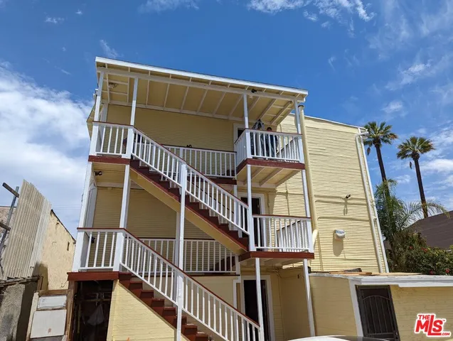 a view of balcony with wooden floor and fence