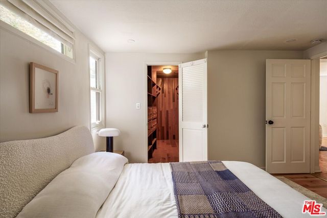 a bedroom with a bed and a mirror