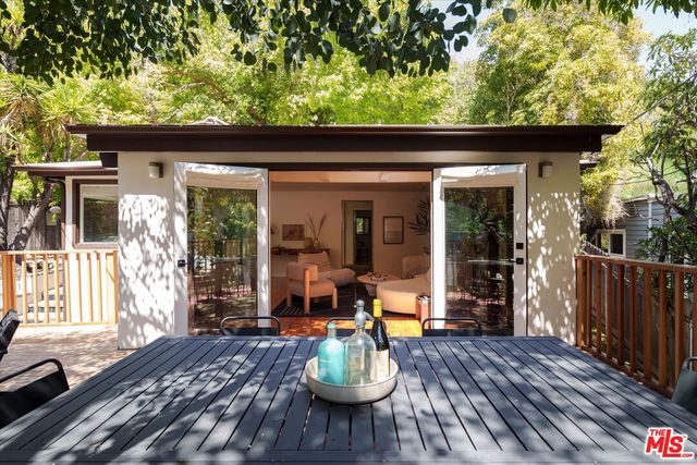 a view of a patio with a table chairs and a potted plant