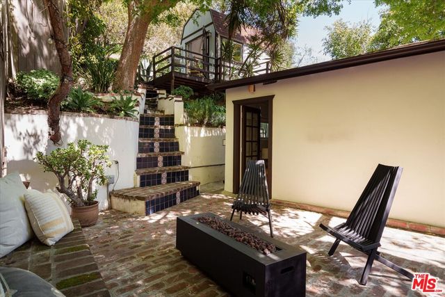 a view of backyard of house with outdoor seating
