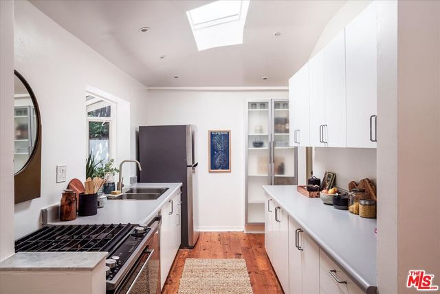 a kitchen with a sink stove and refrigerator