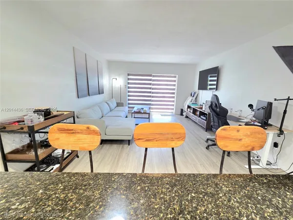 a living room with furniture and a lamp