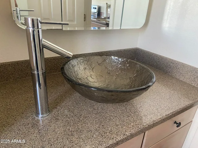 a bedroom with a bed and a mirror