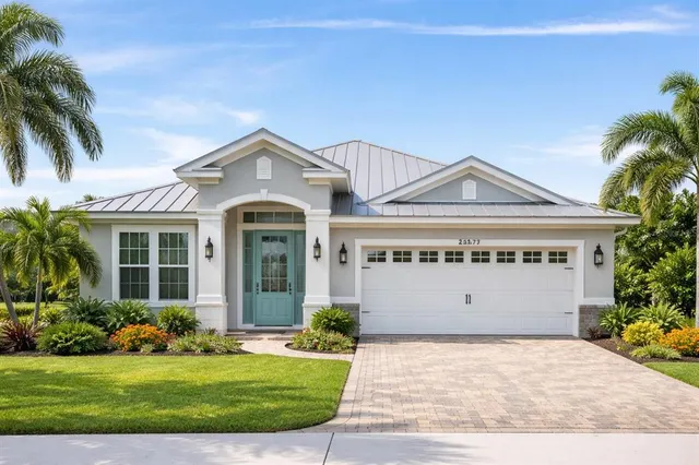 a front view of a house with a yard and garage