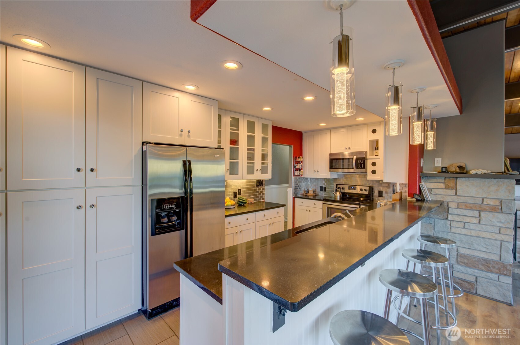 2144 Reservoir Road Ilwaco, WA 98624 - Photo 12 of 31 a kitchen with stainless steel appliances granite countertop a refrigerator a oven and a sink with cabinets