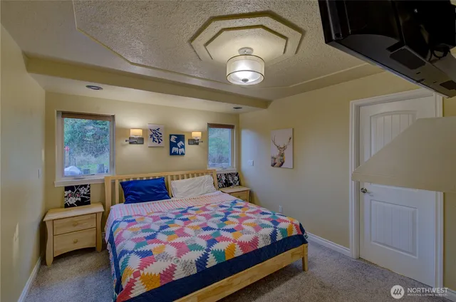 a bedroom with a bed and a chandelier