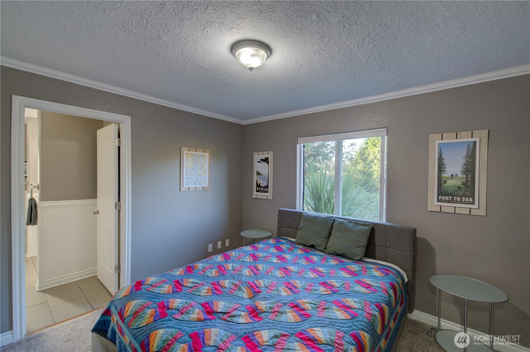 2144 Reservoir Road Ilwaco, WA 98624 - Photo 19 of 31 a bedroom with a bed and a lamp next to a window
