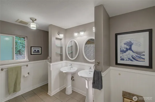 a bathroom with a toilet a sink and a mirror