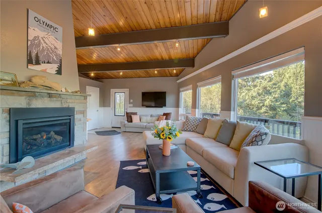 a living room with furniture a fireplace and a flat screen tv