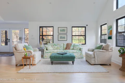 a dining room with furniture a rug and wooden floor