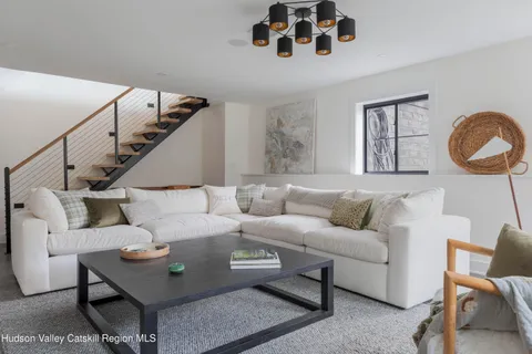 a kitchen with stainless steel appliances a table chairs refrigerator and cabinets