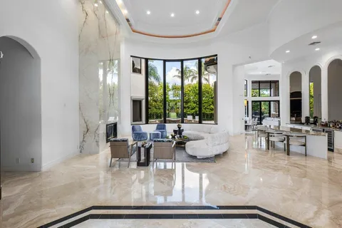 a living room with furniture and large windows