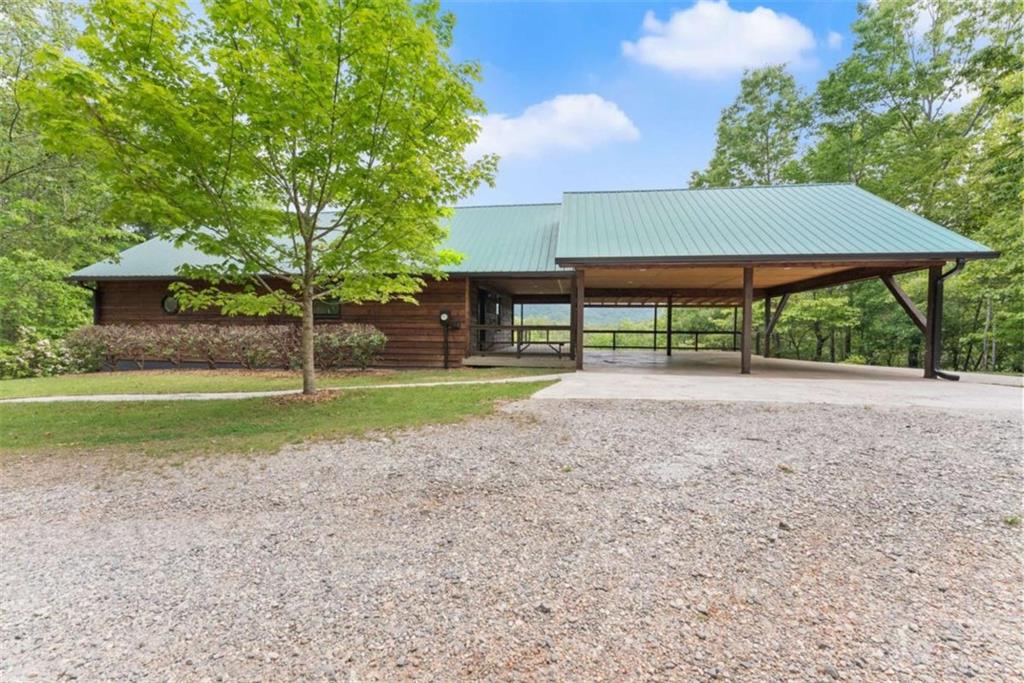 707 South Fern Cove Road Sautee Nacoochee, GA 30571 - Photo 5 of 60 a house with green field in front of it