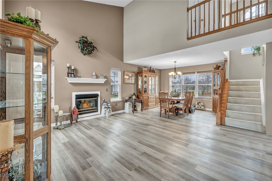 3887 Reeves Lane Medina, OH 44256 - Photo 9 of 42 Living room with a chandelier, a high ceiling, and light hardwood / wood-style flooring