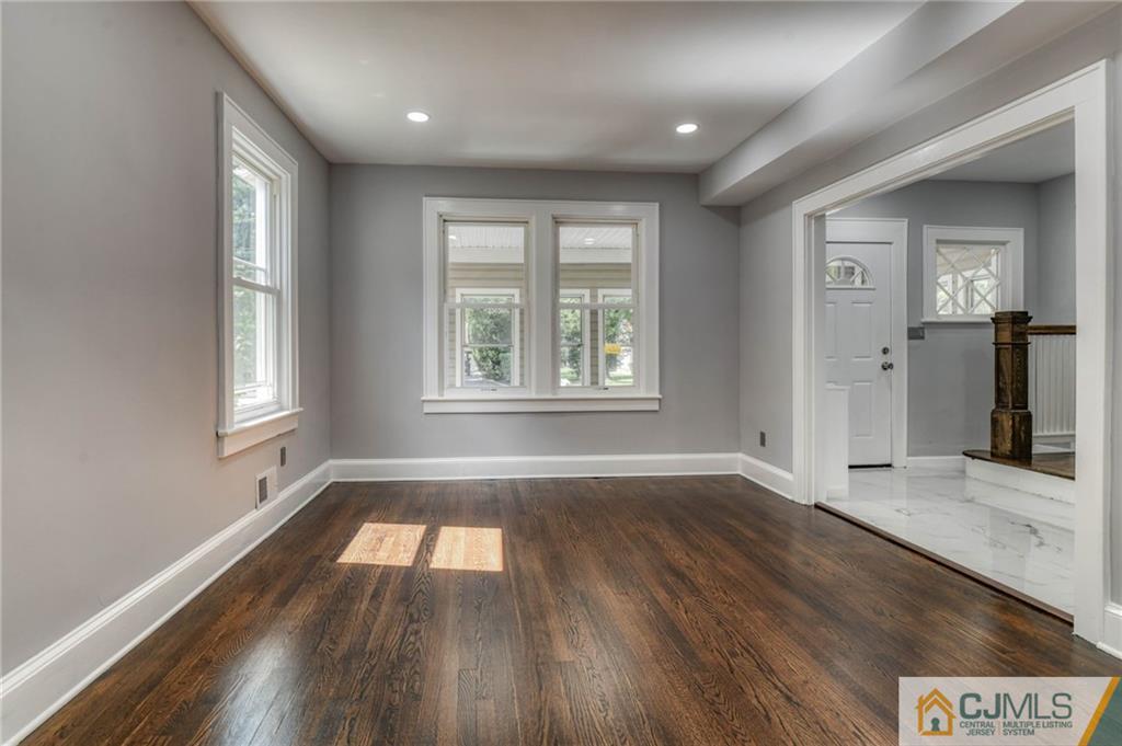 800 Old Raritan Road Edison, NJ 08820 - Photo 6 of 31 an empty room with wooden floor and windows
