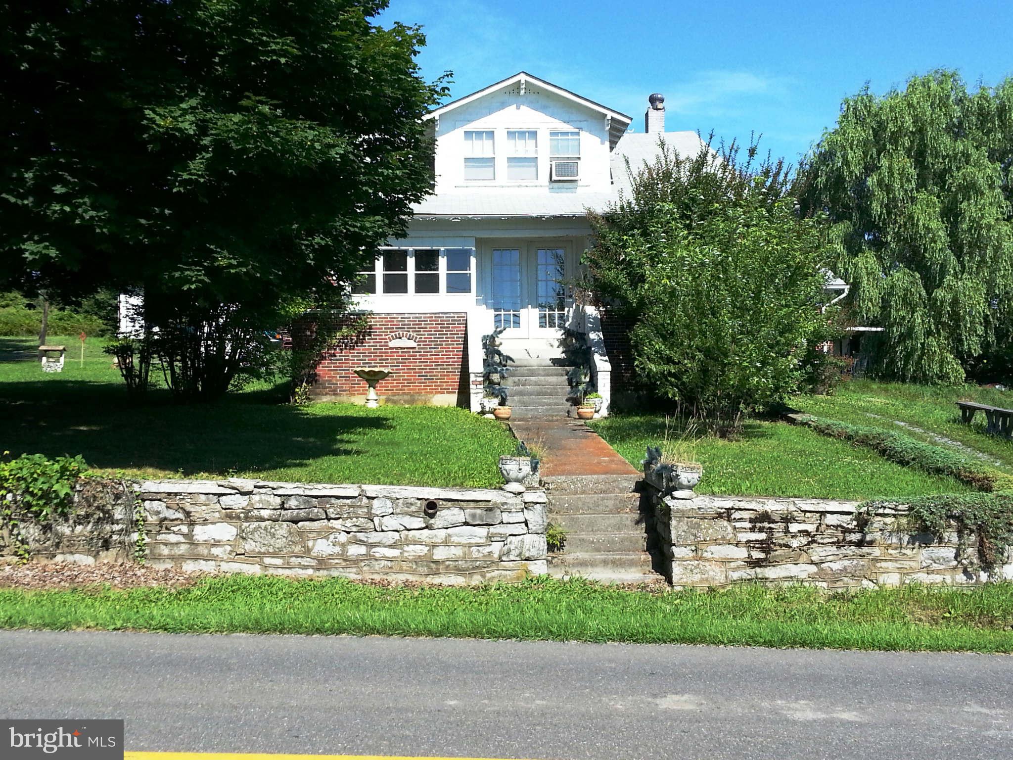 3355 Apple Pie Ridge Road Winchester, VA 22603 - Photo 1 of 29 a front view of a house with a yard and garage