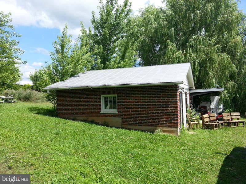 3355 Apple Pie Ridge Road Winchester, VA 22603 - Photo 22 of 29 a backyard of a house with table and chairs
