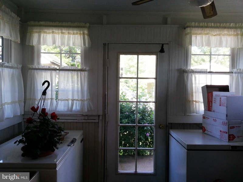 3355 Apple Pie Ridge Road Winchester, VA 22603 - Photo 6 of 29 a room with a window wooden floor and potted plant