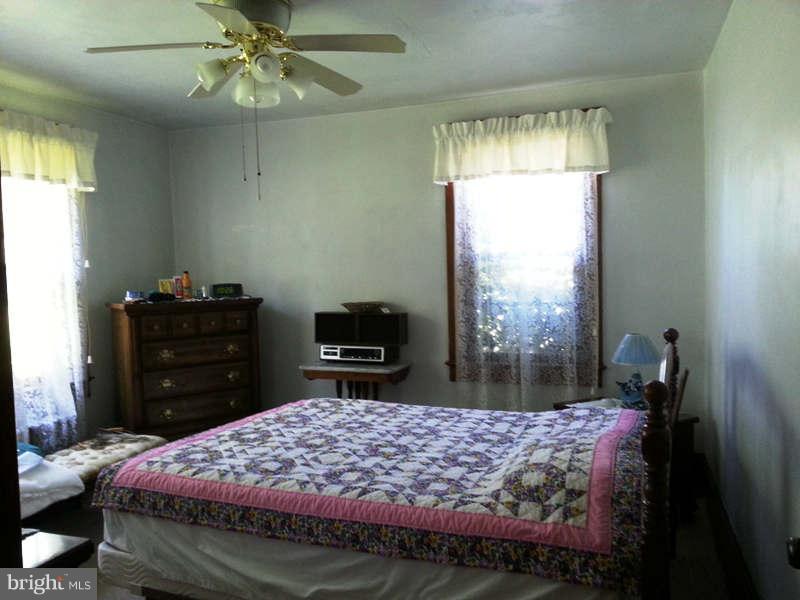3355 Apple Pie Ridge Road Winchester, VA 22603 - Photo 7 of 29 a bed room with a bed and a television