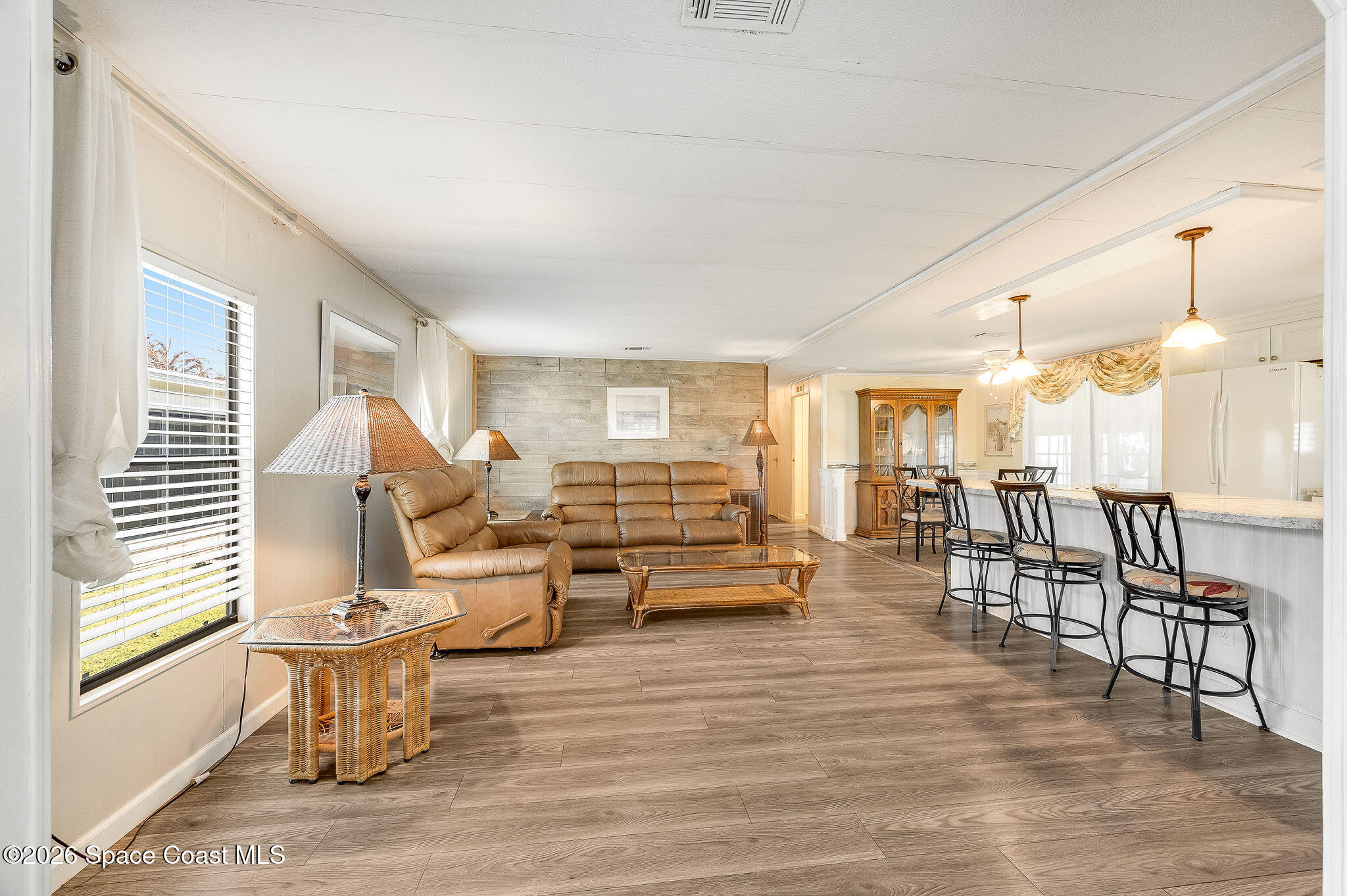 811 Silverthorn Court Barefoot Bay, FL 32976 - Photo 11 of 74 a living room with furniture and wooden floor