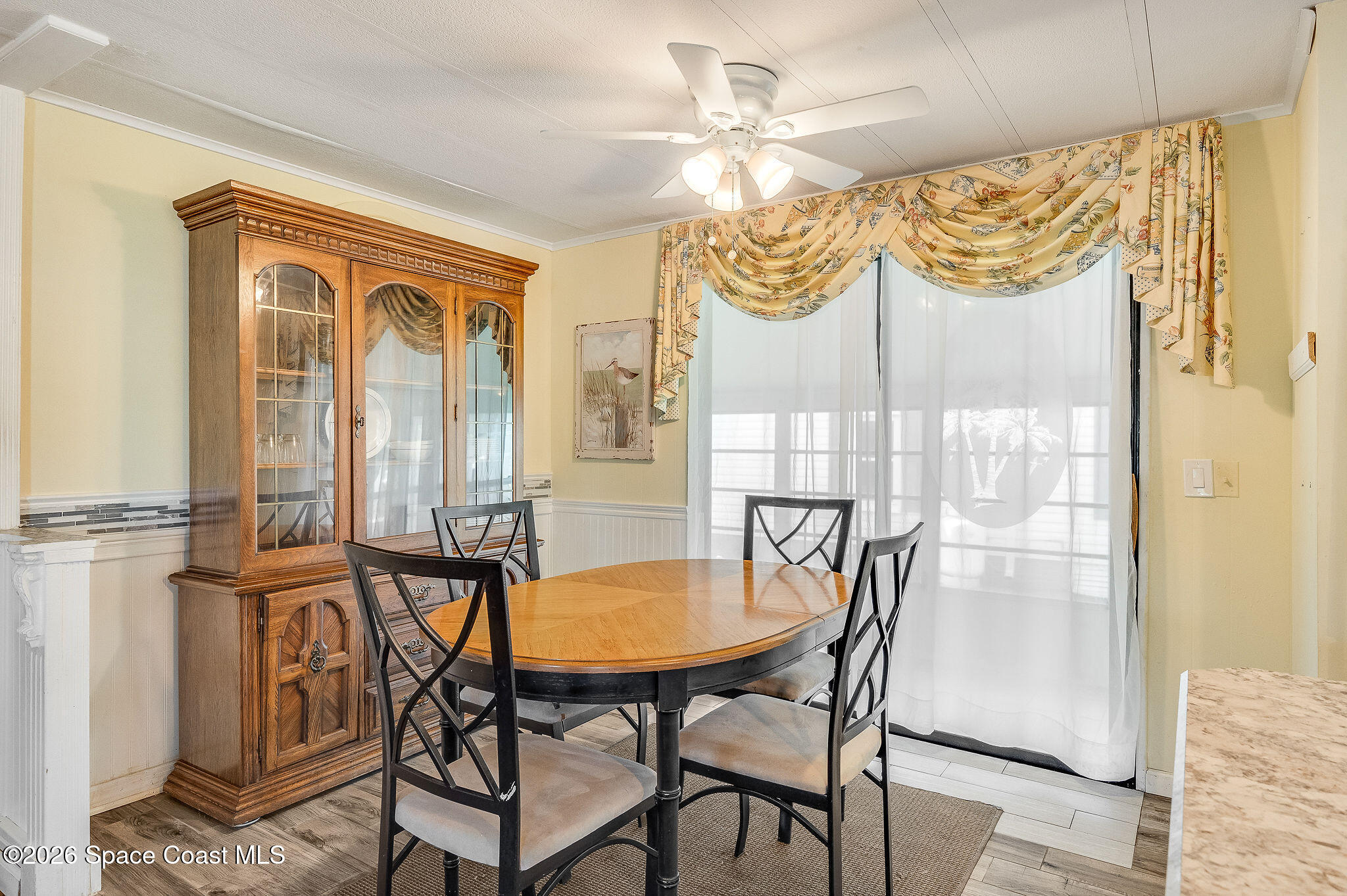 811 Silverthorn Court Barefoot Bay, FL 32976 - Photo 19 of 74 a view of a dining room with furniture window and outside view