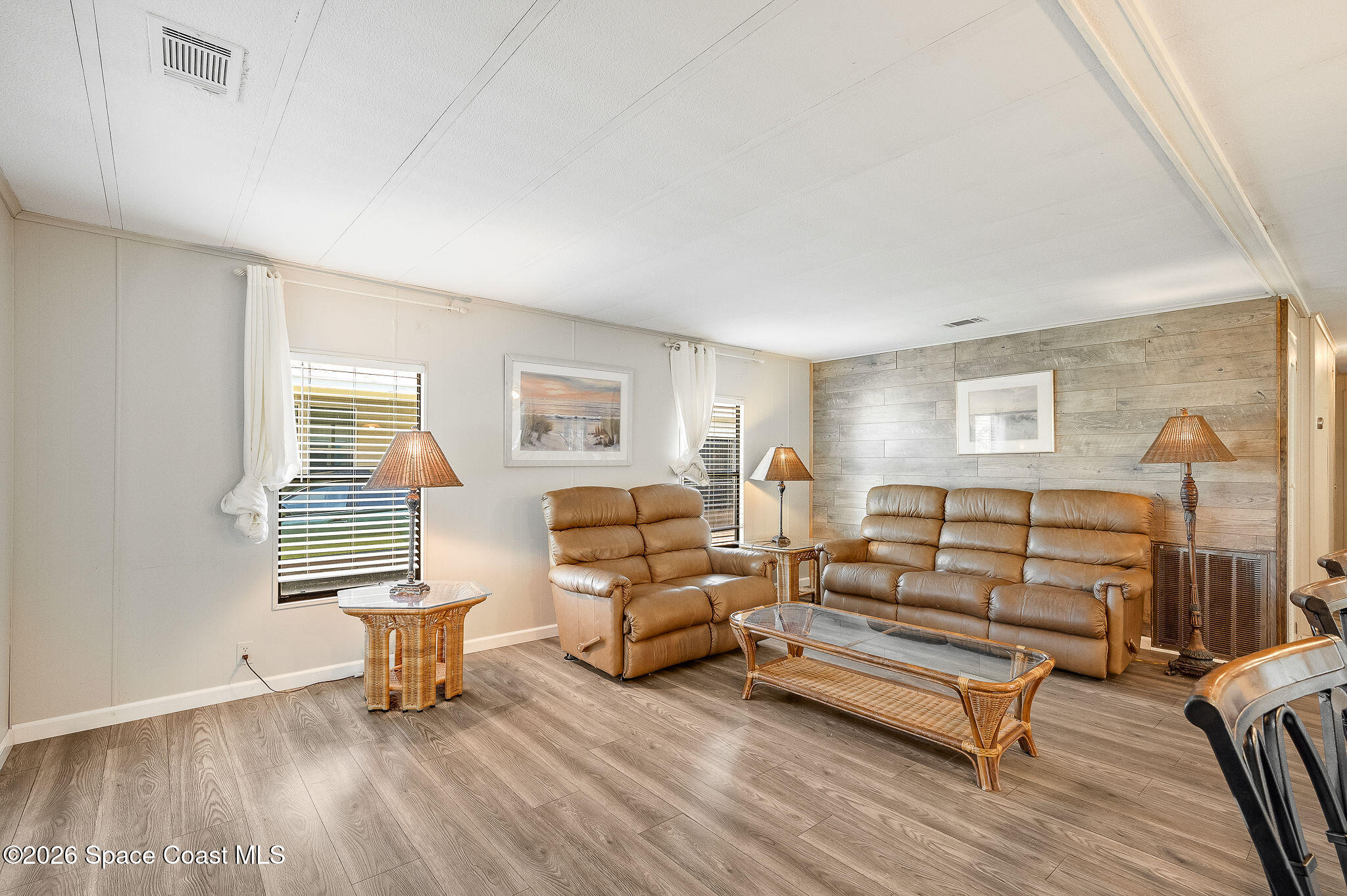811 Silverthorn Court Barefoot Bay, FL 32976 - Photo 22 of 74 a living room with furniture and wooden floor