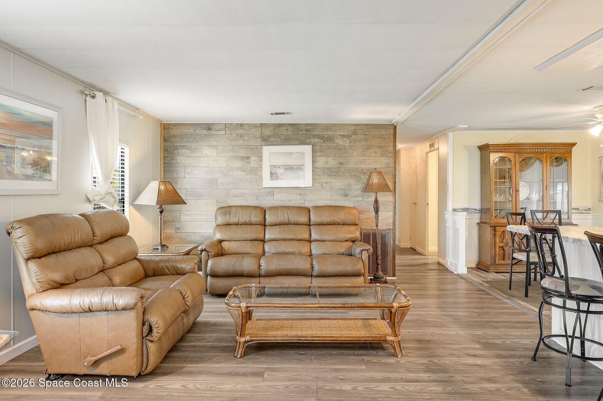 811 Silverthorn Court Barefoot Bay, FL 32976 - Photo 25 of 74 a living room with furniture and wooden floor