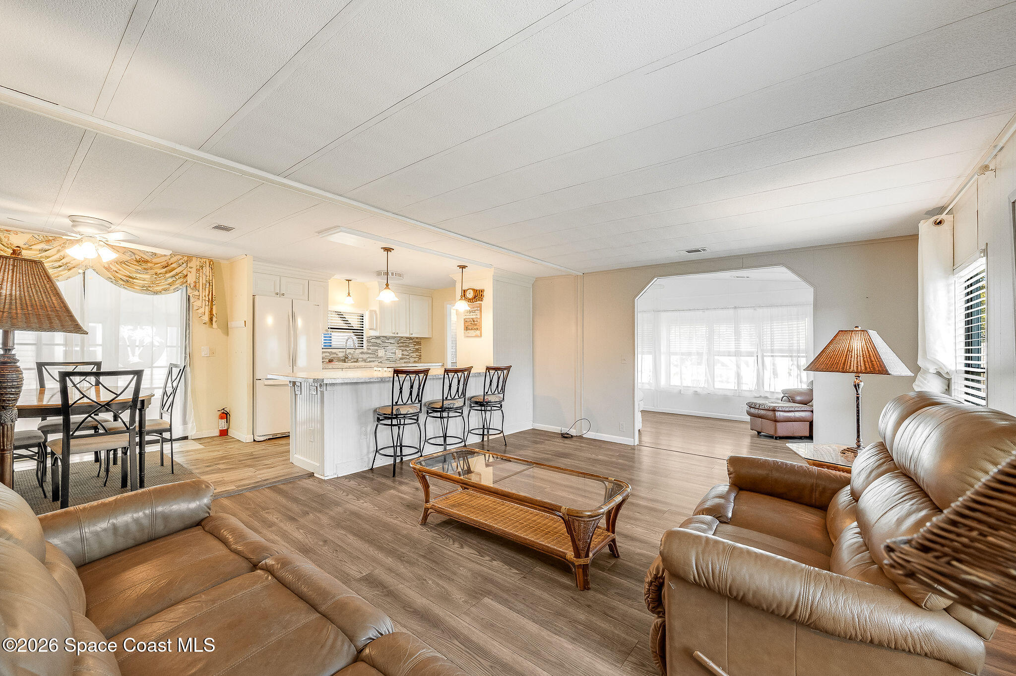 811 Silverthorn Court Barefoot Bay, FL 32976 - Photo 26 of 74 a living room with furniture and a table