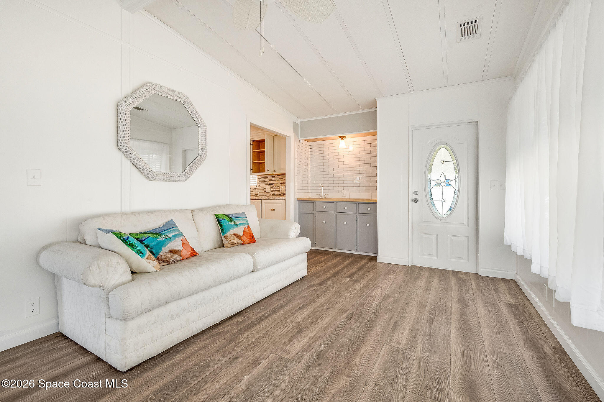811 Silverthorn Court Barefoot Bay, FL 32976 - Photo 4 of 74 a living room with furniture and a wooden floor