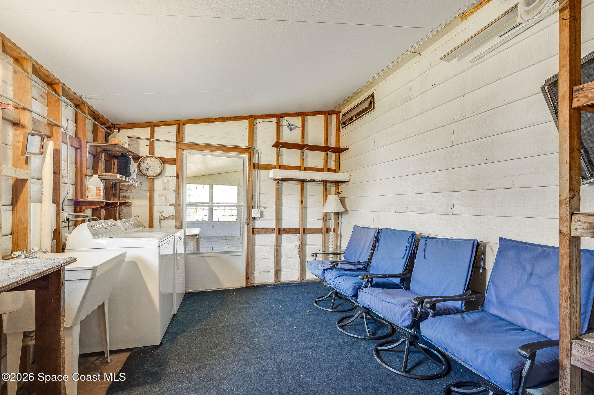 811 Silverthorn Court Barefoot Bay, FL 32976 - Photo 41 of 74 a room with furniture and a window