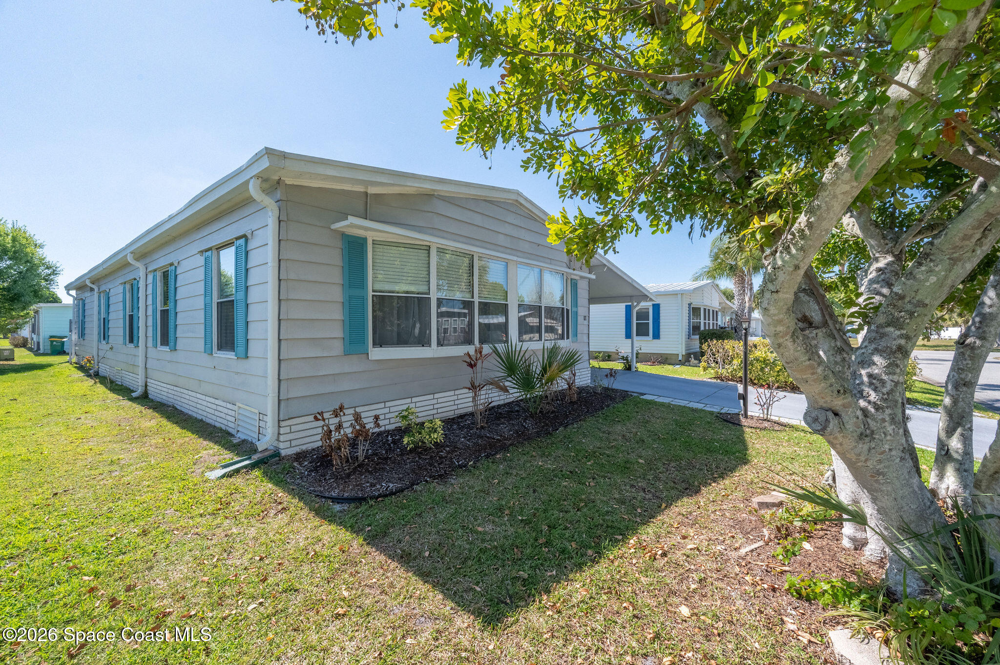 811 Silverthorn Court Barefoot Bay, FL 32976 - Photo 47 of 74 a view of house with backyard and sitting area