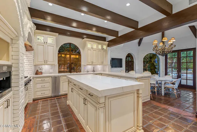 a large white kitchen with a large window